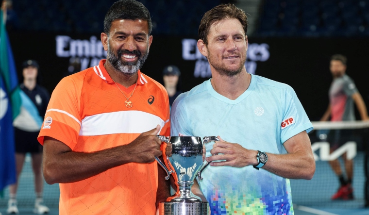 India's Rohan Bopanna (L) and Australia's Matthew Ebden with the trophy | AFP
